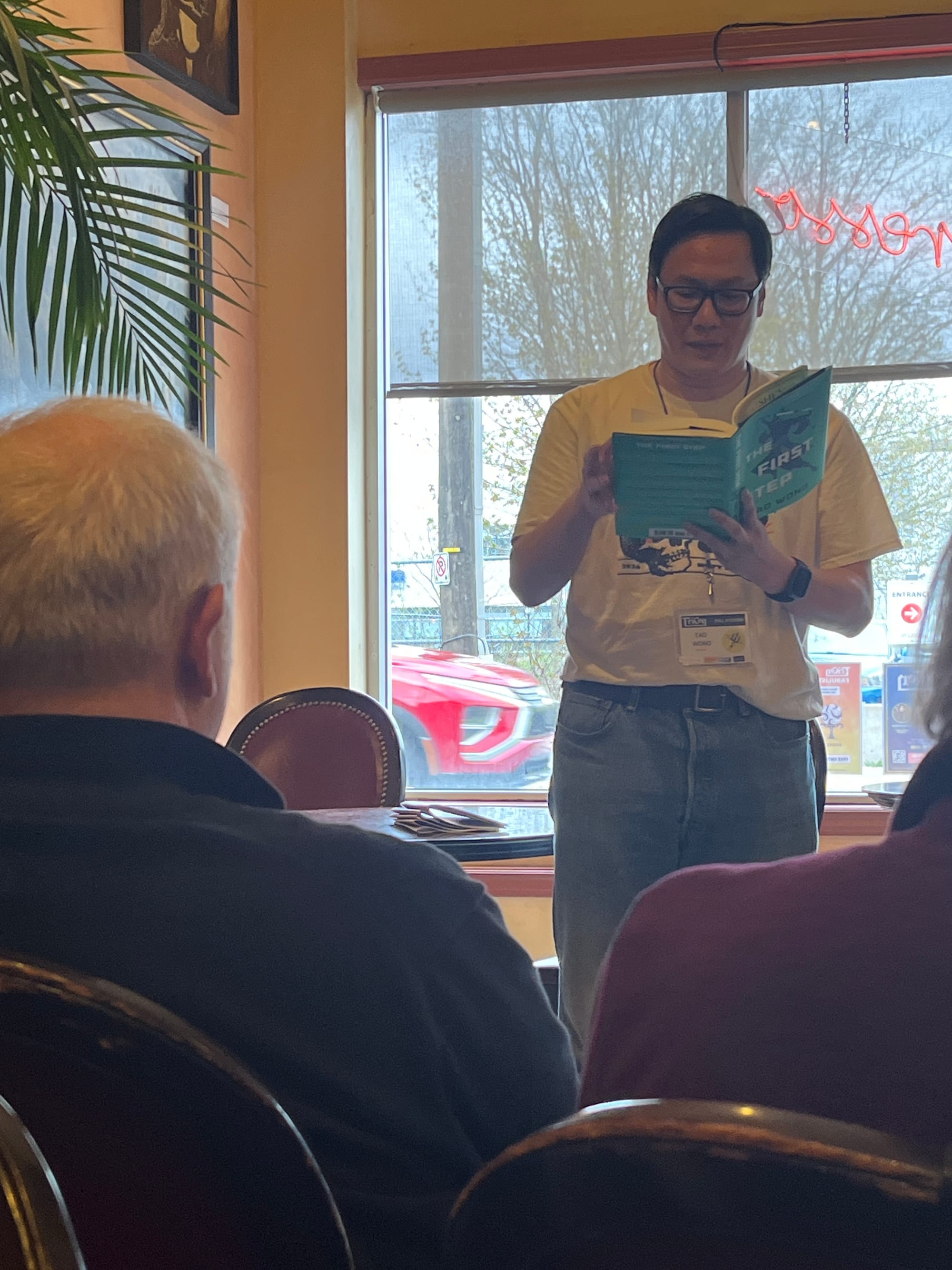 Author Tao Wong reading in front of an audience