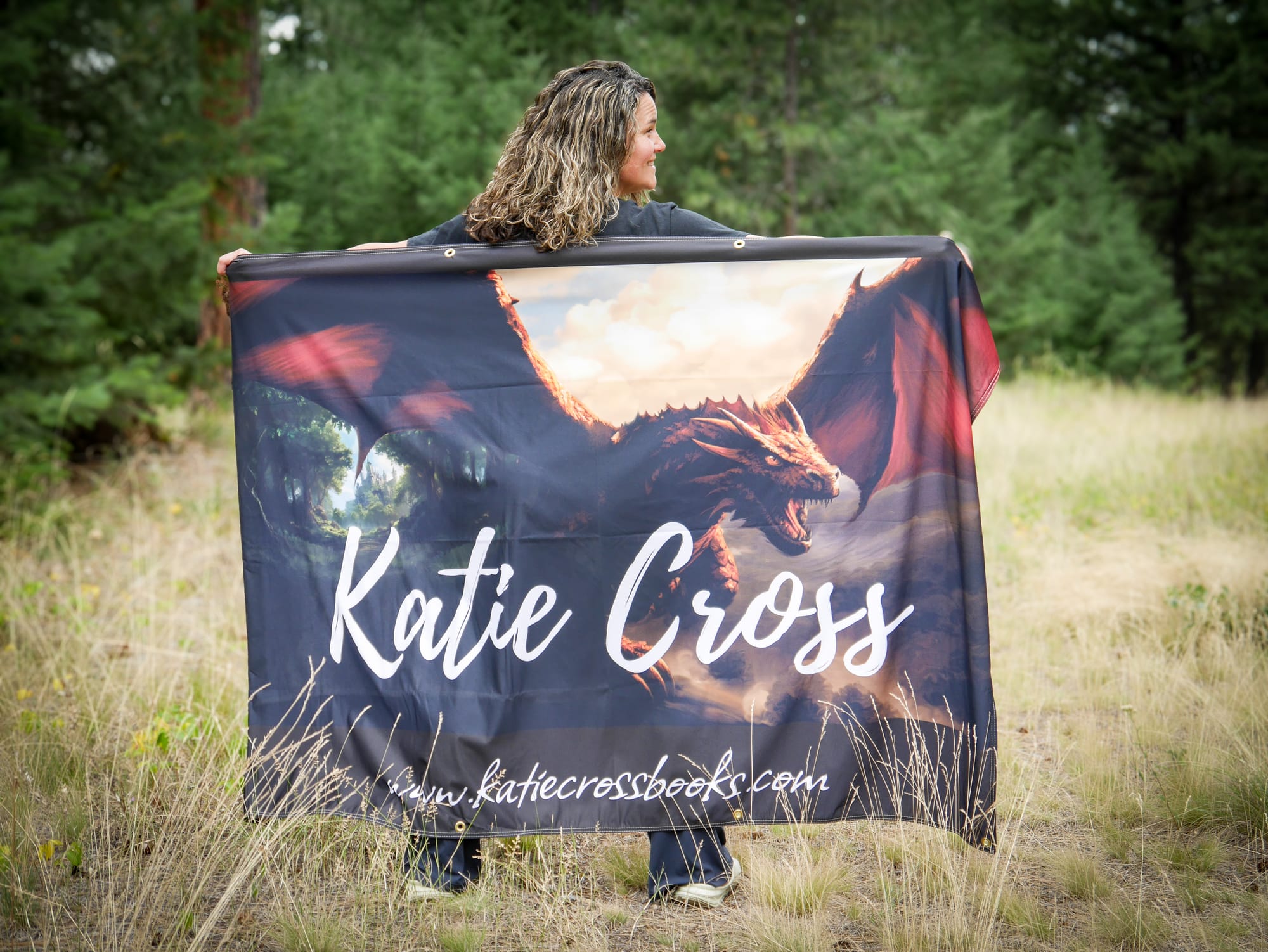 Katie Cross poses with author banner