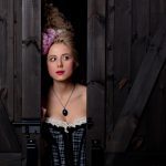 beautiful blonde countess with vintage hairstyle and corset