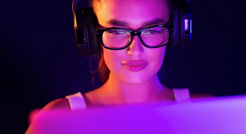 Gamer girl playing video game, wearing headset